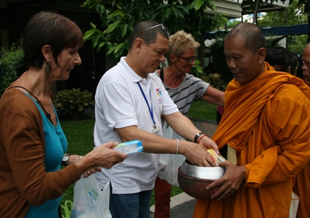 Foreign volunteers make merit on Father Ray Day.